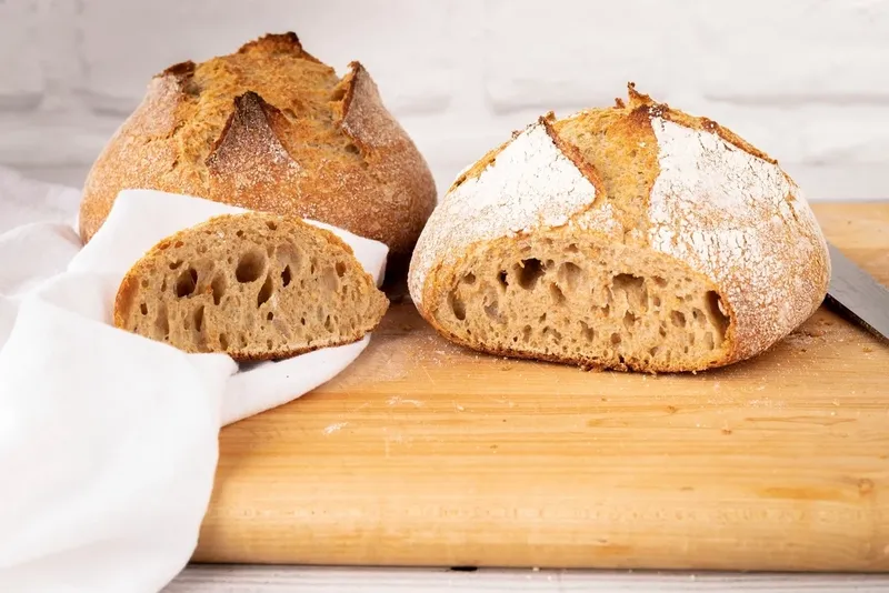 Sliced sourdough loaves on a wooden board
