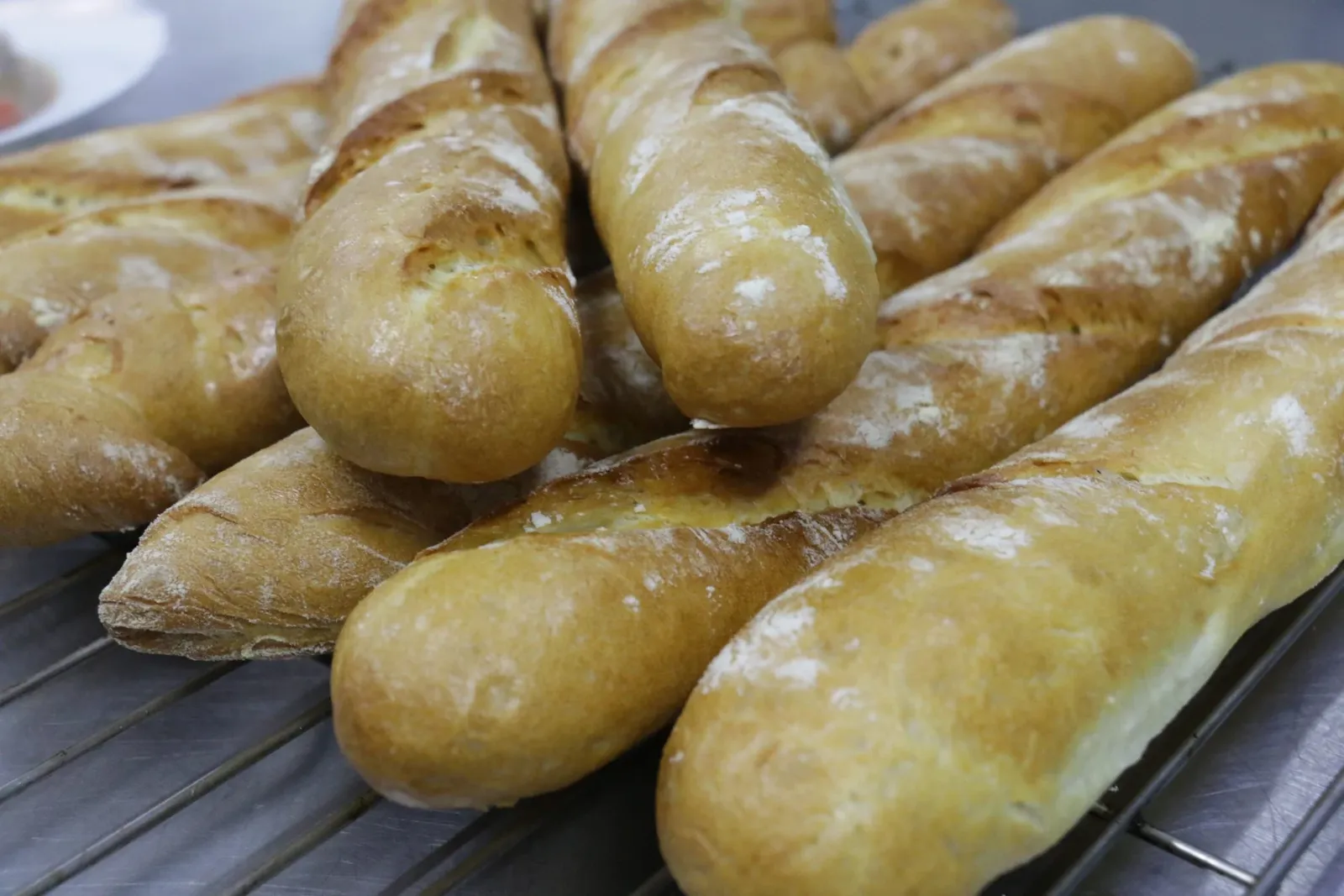 Golden baguettes fresh from the oven on a cooling rack